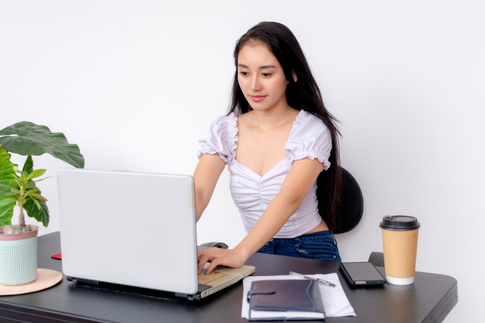 Young woman studying marketing concepts related to oral surgeon marketing strategy