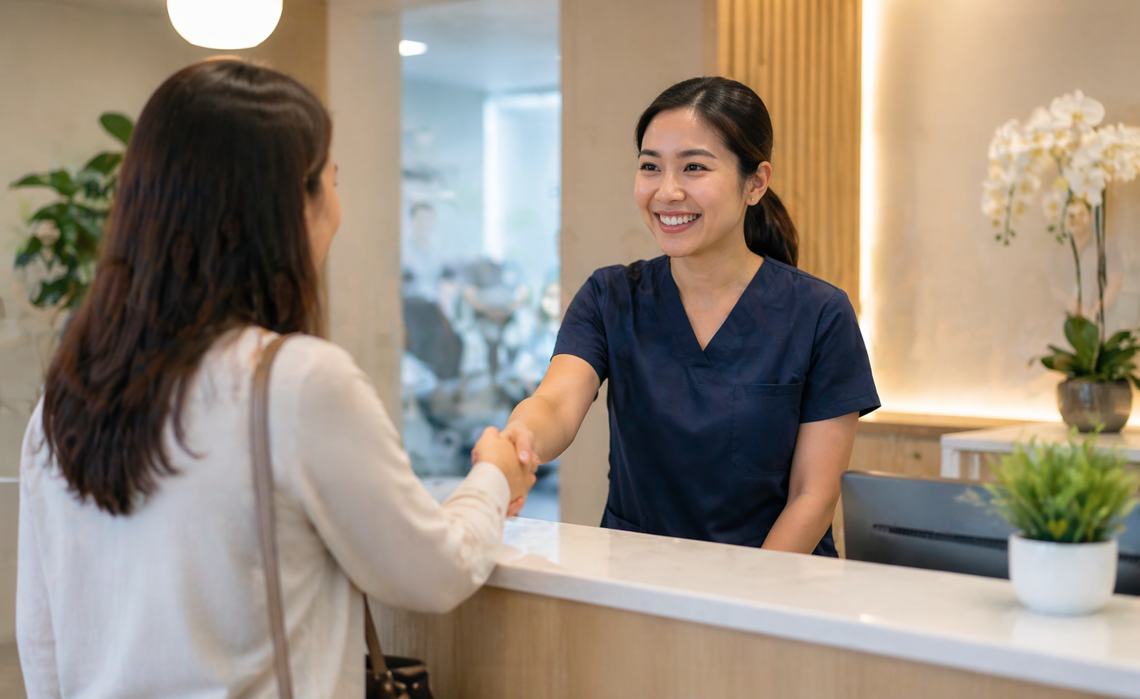 Smiling dental receptionist in scrubs with natural office lighting